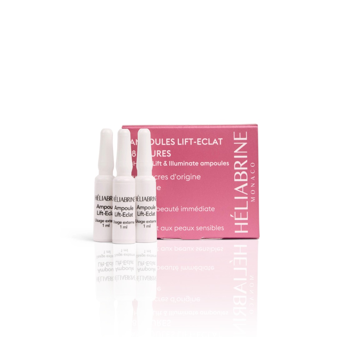 Na sliki je roza škatlica, levo od nje pa 3 pokončne bele ampule. Napis Héliabrine Lifting ampule.